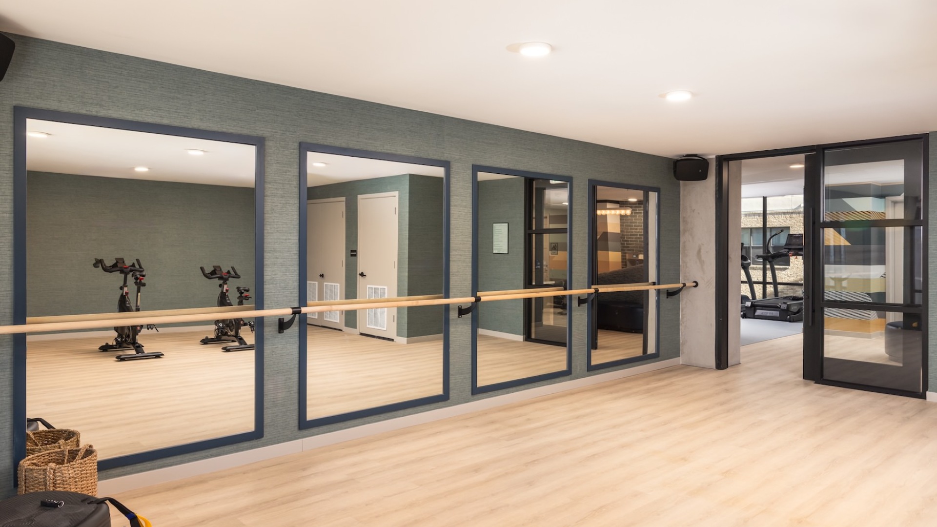 fitness studio with a large mirror and stationary bikes
