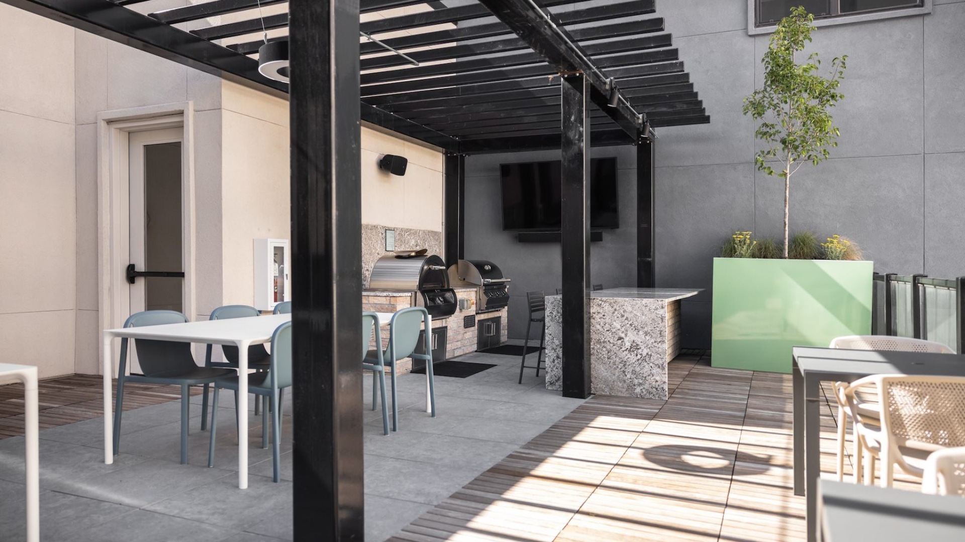 outdoor grill area with tables and chairs