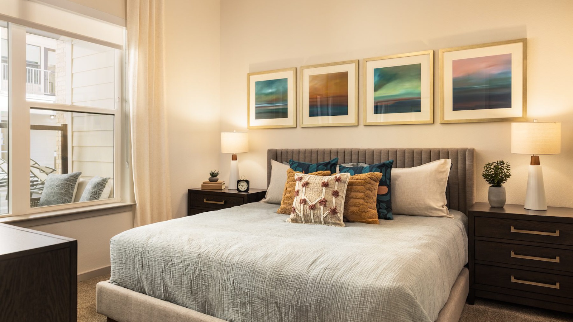 bedroom with nightstands on each side of the bed and large window