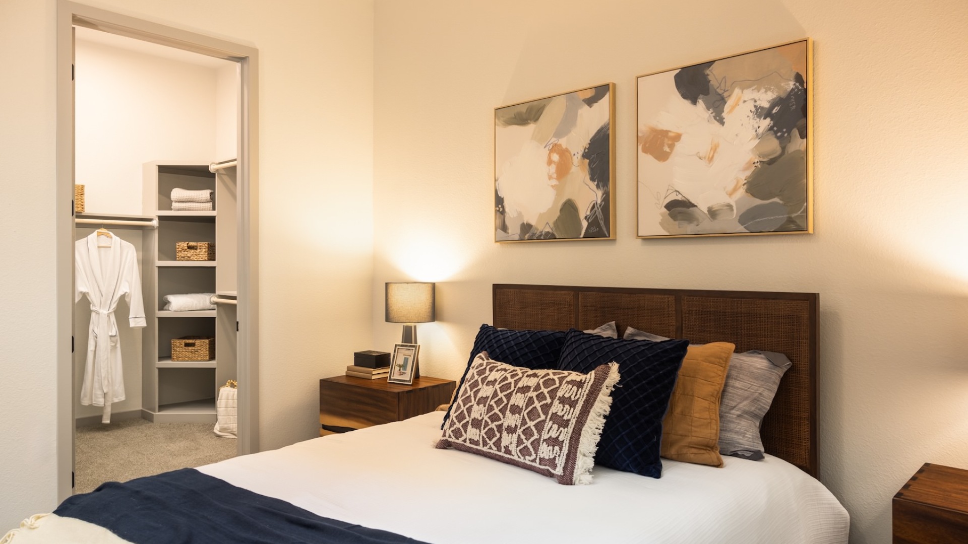 bedroom with nightstands on each side of the bed and large walk-in closet